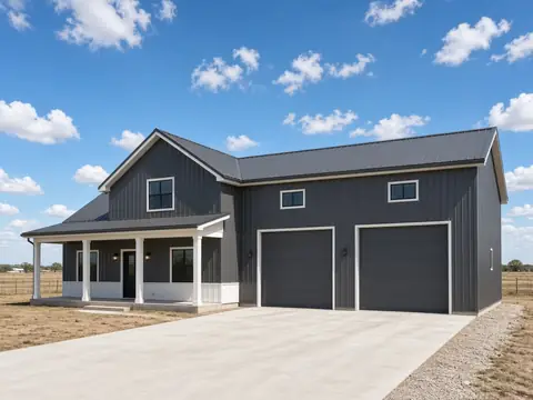 Charcoal metal barndominium with a porch and two tall shop doors
